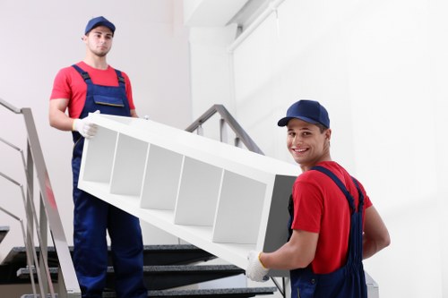 Furniture being moved through a narrow Paddington staircase
