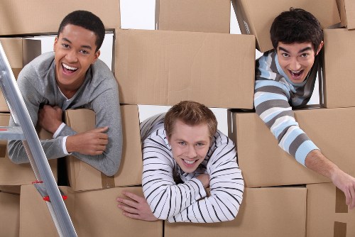 Packed business equipment and labelled boxes ready for relocation