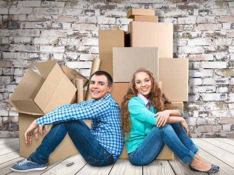 Packed moving boxes and furniture prepared for collection in a Paddington home